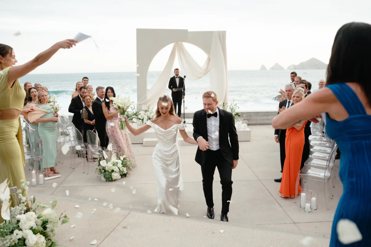 cabo destination wedding ceremony exit engaging events by ali chicago planner the cape thompson hotel - Luxury Cabo Wedding at The Cape, a Thompson Hotel Luxury destination wedding ceremony exit at The Cape Thompson Hotel in Cabo San Lucas planned by Chicago wedding planner Engaging Events by Ali with oceanview ceremony setup