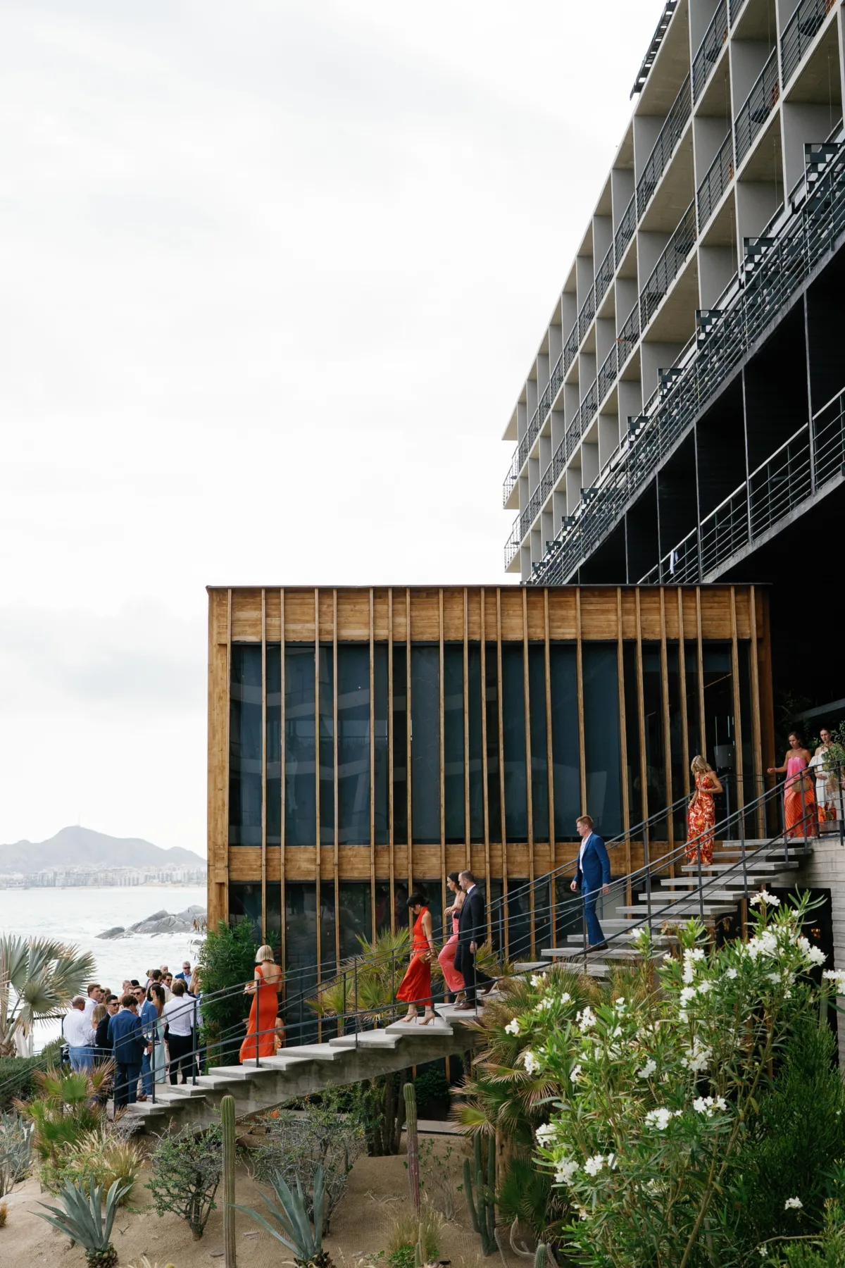 cabo destination wedding ceremony the cape thompson hotel engaging events ali - Luxury Cabo Wedding at The Cape, a Thompson Hotel Luxury destination wedding ceremony at The Cape Thompson Hotel in Cabo San Lucas with guests walking up modern architectural stairs planned by Chicago wedding planner Engaging Events by Ali