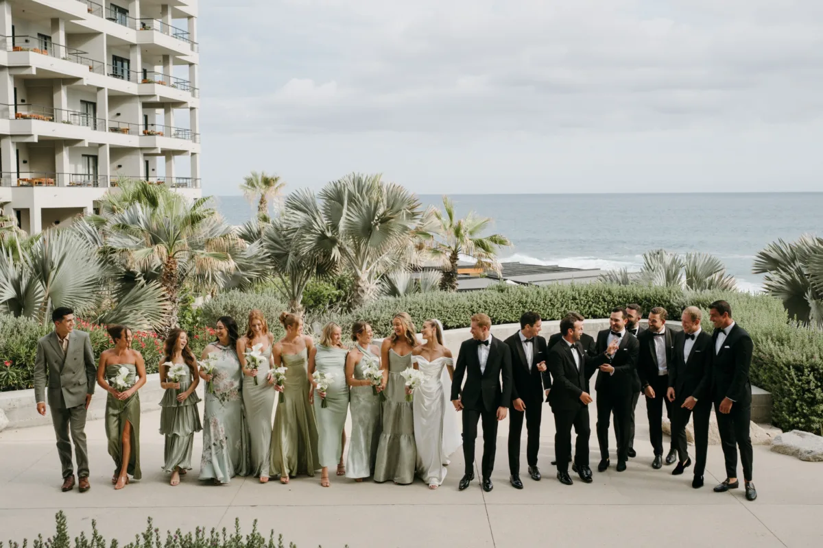 cabo destination wedding party the cape thompson hotel engaging events - Luxury Cabo Wedding at The Cape, a Thompson Hotel Wedding party portrait at luxury Cabo destination wedding at The Cape Thompson Hotel planned by Engaging Events by Ali with sage green bridesmaids dresses and black tuxedos