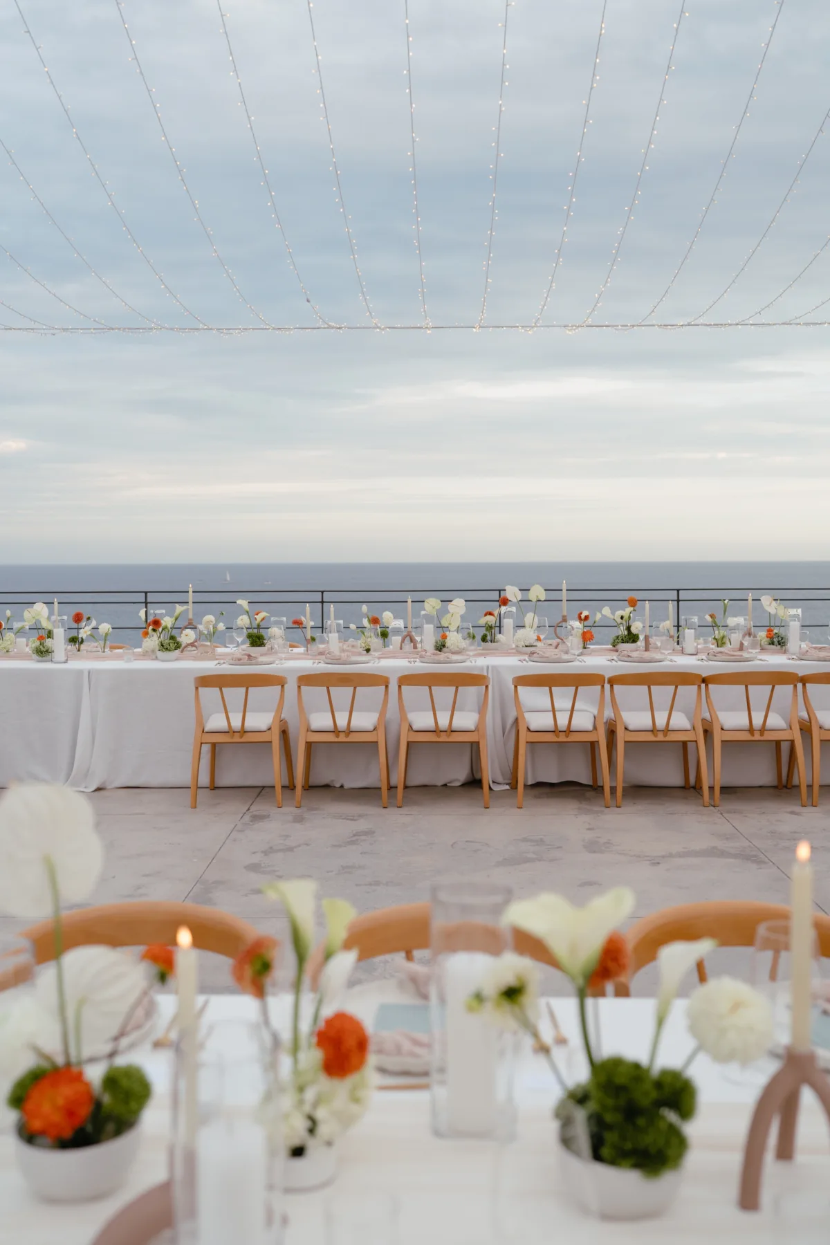 cabo destination wedding tablescape aria vera floral cape thompson hotel - Luxury Cabo Wedding at The Cape, a Thompson Hotel Luxury destination wedding reception tablescape with ocean view at The Cape Thompson Hotel in Cabo San Lucas featuring floral arrangements by Aria Vera Floral and coordinated by Chicago wedding planner Engaging Events by Ali