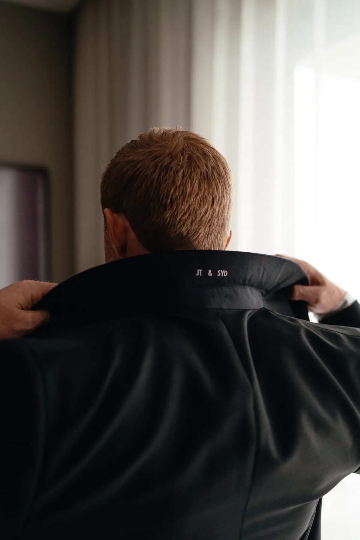 groom monogrammed jacket cabo destination wedding the cape thompson hotel - Luxury Cabo Wedding at The Cape, a Thompson Hotel Groom putting on monogrammed wedding jacket while getting ready for luxury destination wedding at The Cape, a Thompson Hotel in Cabo San Lucas