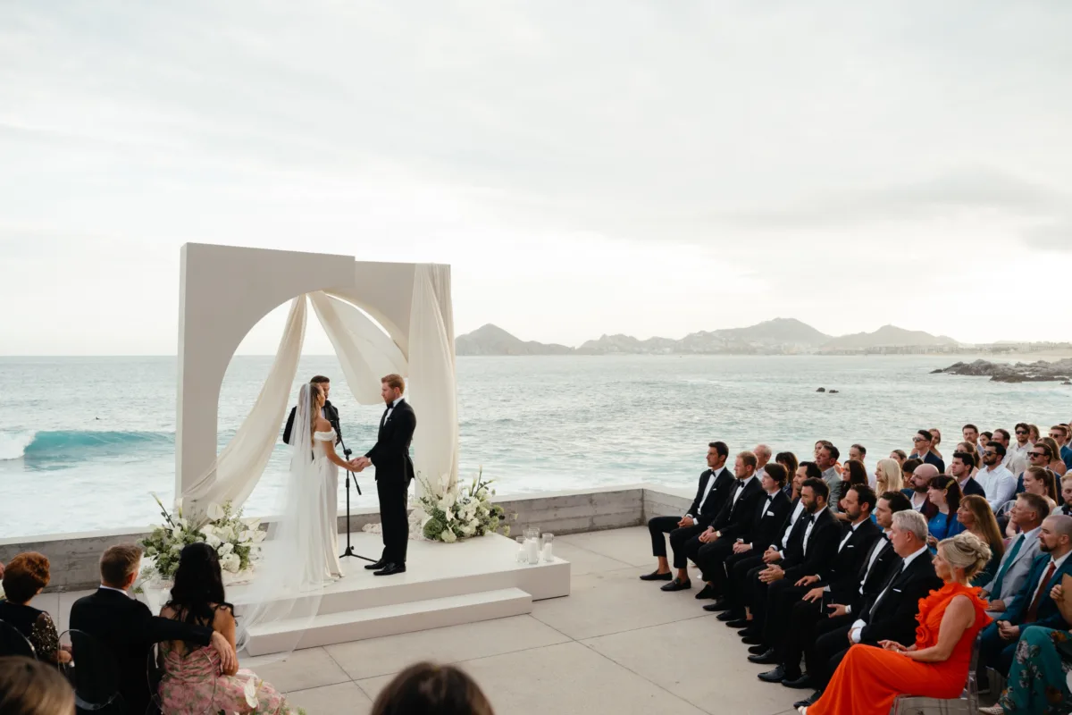luxury cabo beach wedding ceremony engaging events chicago planner - Luxury Cabo Wedding at The Cape, a Thompson Hotel Luxury beach wedding ceremony at The Cape Thompson Hotel in Cabo San Lucas with oceanfront altar and elegant white florals by Aria Vera Floral, planned by Chicago wedding planner Engaging Events by Ali