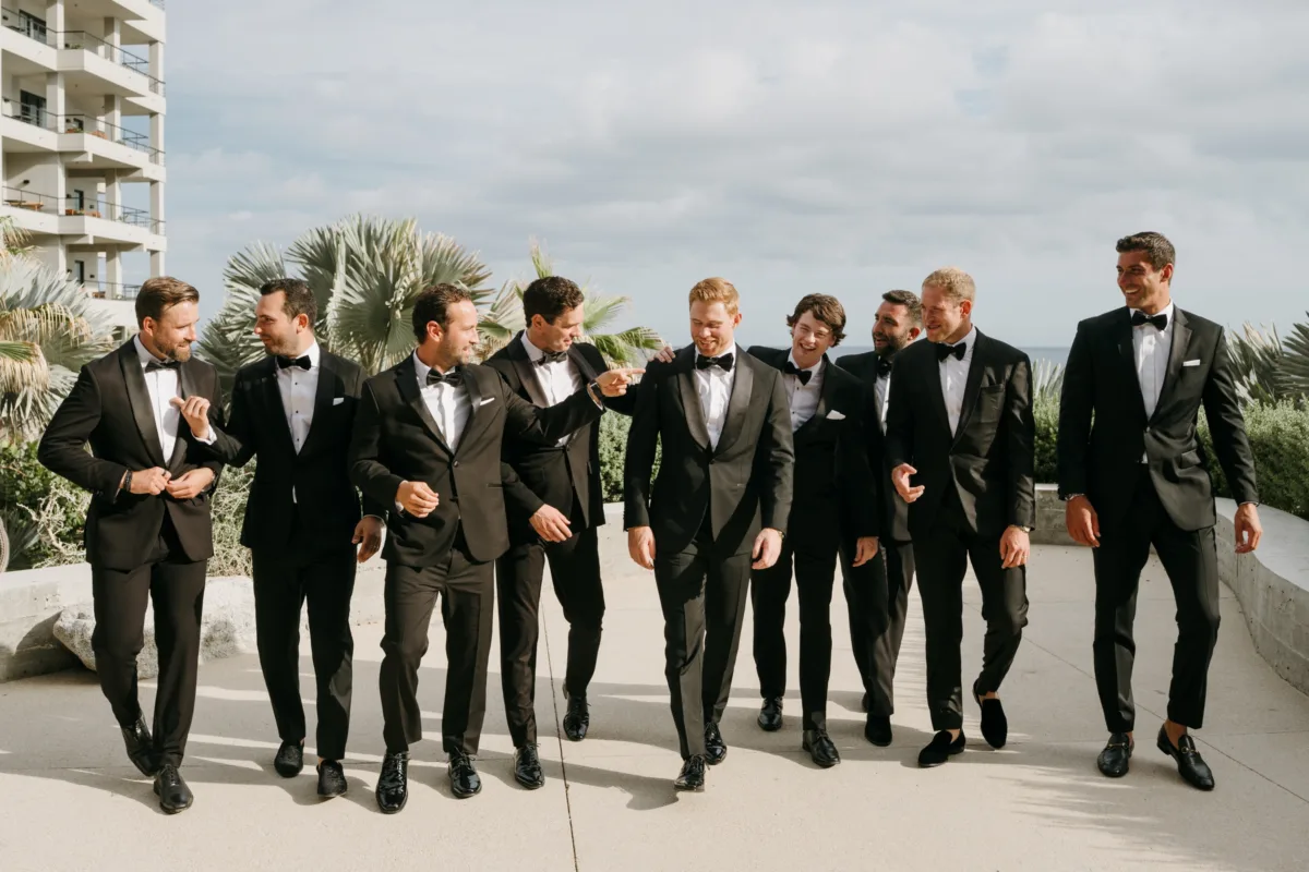 luxury cabo groomsmen wedding planning engaging events by ali cape thompson hotel - Luxury Cabo Wedding at The Cape, a Thompson Hotel Groomsmen in black tuxedos walking at luxury Cabo wedding at The Cape, a Thompson Hotel, planned by Engaging Events by Ali with photography by Efege
