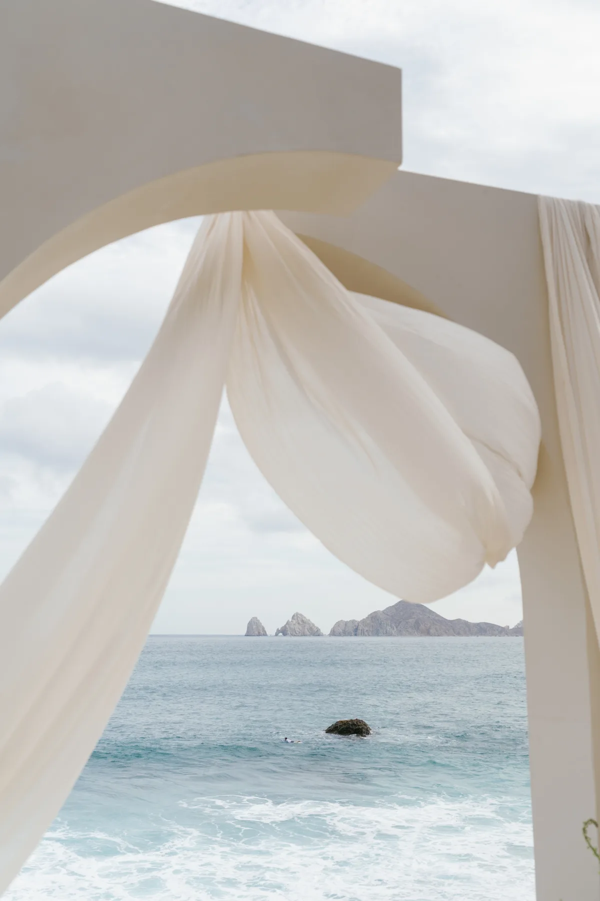 luxury cabo wedding ceremony arch ocean view the cape thompson hotel - Luxury Cabo Wedding at The Cape, a Thompson Hotel Elegant wedding ceremony arch with flowing white fabric overlooking the ocean at The Cape, a Thompson Hotel in Cabo San Lucas
