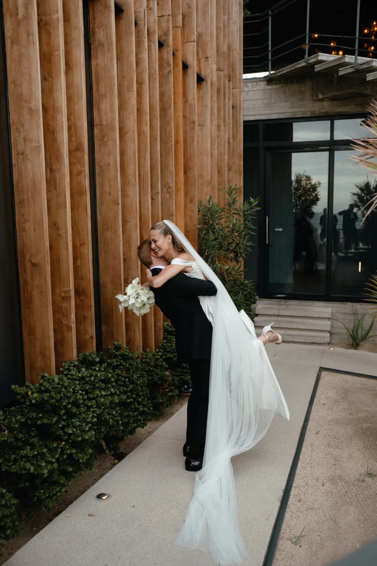 luxury cabo wedding couple embrace engaging events by ali chicago wedding planning - Luxury Cabo Wedding at The Cape, a Thompson Hotel Bride and groom embrace at luxury Cabo wedding at The Cape Thompson Hotel planned by Chicago wedding planner Engaging Events by Ali with photography by Efege