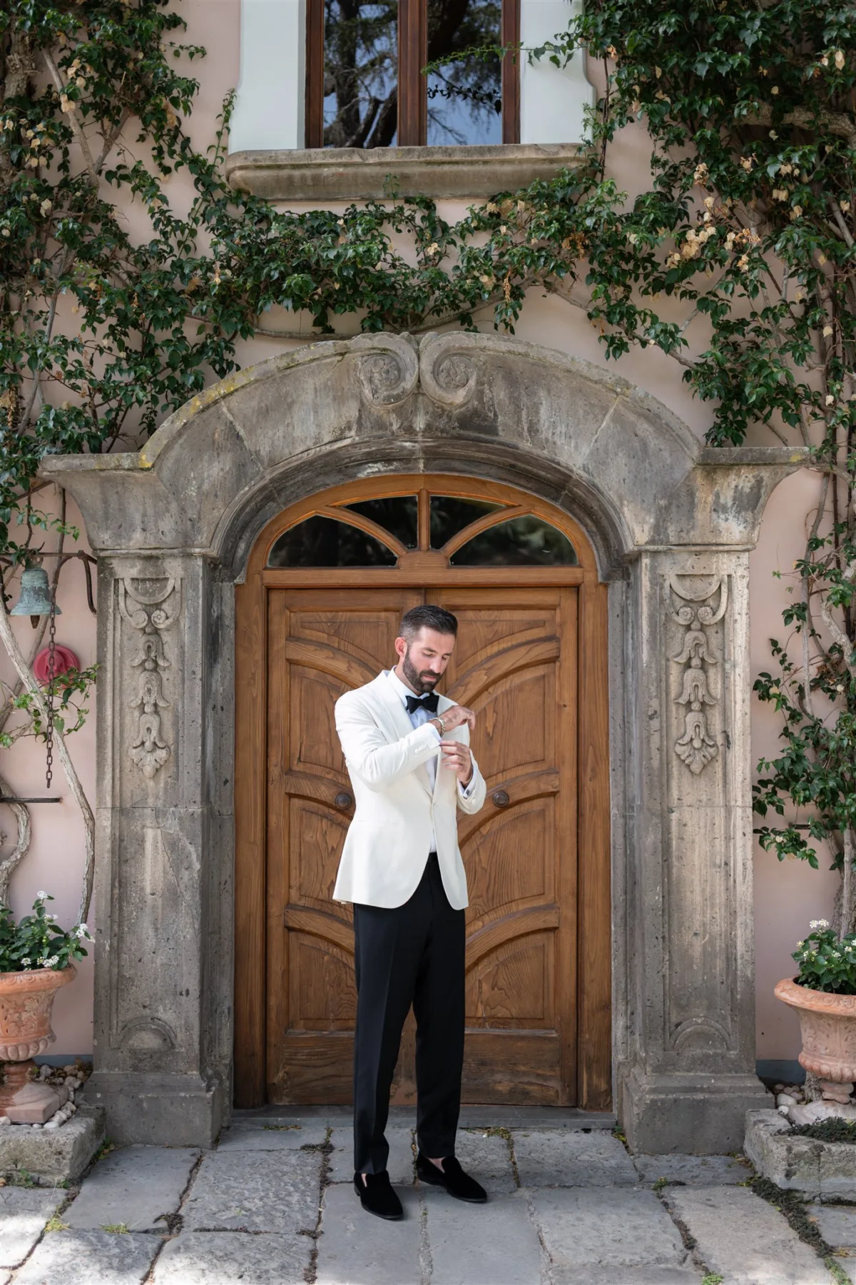amalfi coast groom portrait engaging events capo santa fortunata - An Effortless Amalfi Coast Celebration Groom in white dinner jacket adjusting cufflinks at Capo Santa Fortunata villa in Sorrento Italy, destination wedding planning by Engaging Events by Ali