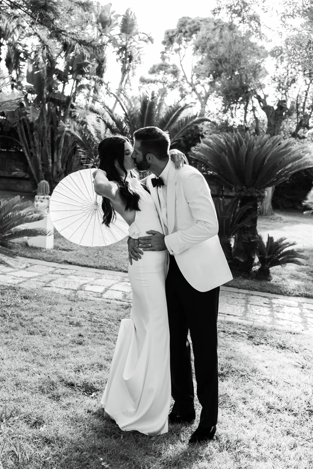 amalfi coast wedding planning engaging events ali sorrento italy 1 - An Effortless Amalfi Coast Celebration Romantic black and white wedding portrait of bride and groom kissing in tropical garden setting at Capo Santa Fortunata in Sorrento Italy, planned by Engaging Events by Ali and photographed by Vincent Aiello
