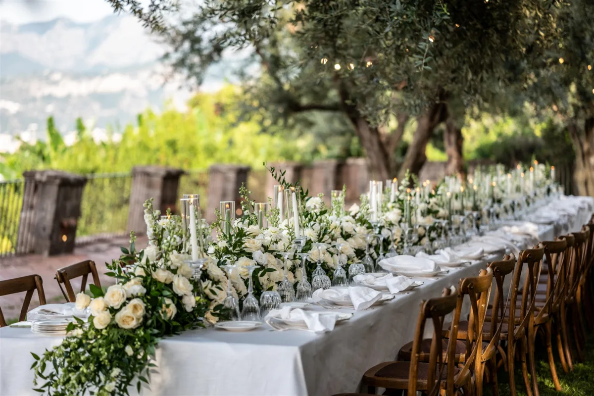 amalfi coast wedding planning engaging events ali sorrento italy 2 - An Effortless Amalfi Coast Celebration Elegant outdoor wedding reception table with white floral centerpieces at Capo Santa Fortunata in Sorrento Italy planned by Engaging Events by Ali