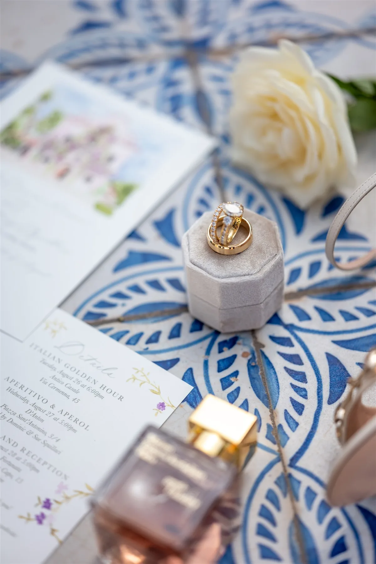 amalfi coast wedding rings sorrento italy engaging events planning - An Effortless Amalfi Coast Celebration Gold wedding rings displayed in velvet box with invitation details at Capo Santa Fortunata venue in Sorrento Italy planned by Engaging Events by Ali