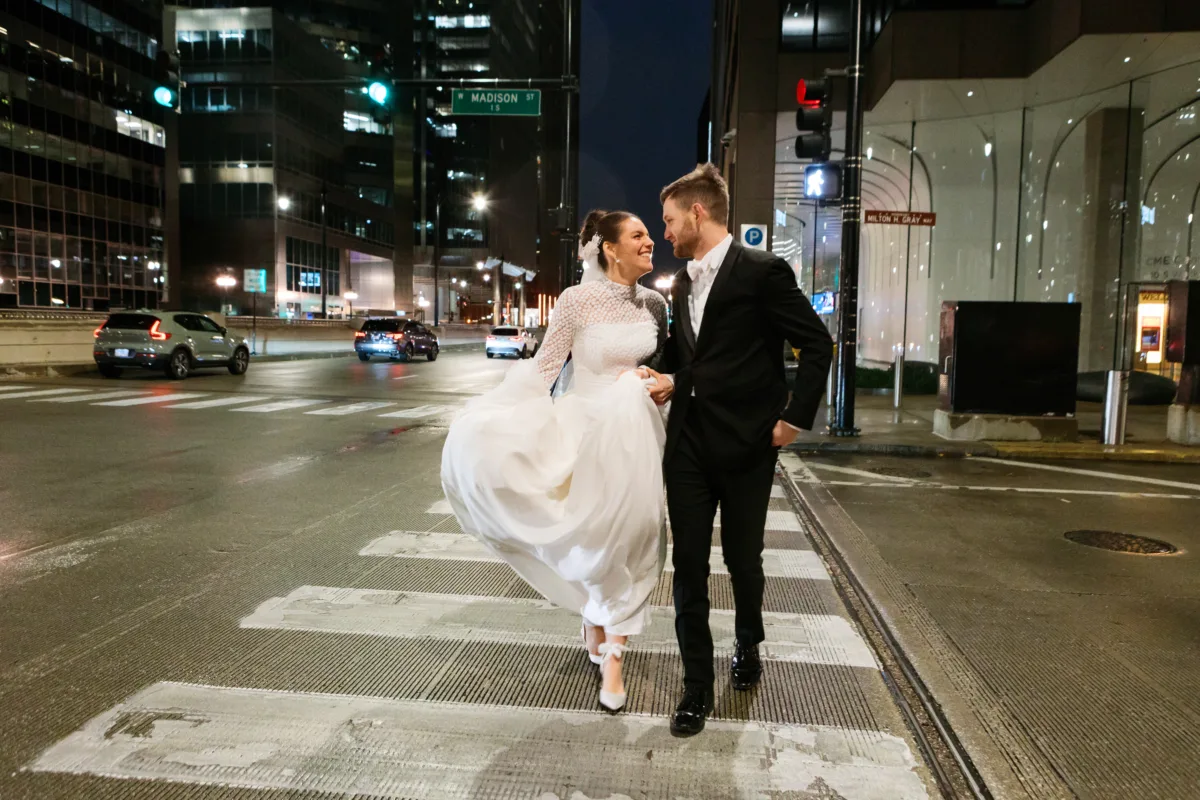 chicago downtown wedding planning engaging events by ali - A Golden Ritz-Carlton Chicago Celebration Bride and groom crossing Chicago downtown street at night after their Ritz-Carlton wedding planned by Engaging Events by Ali