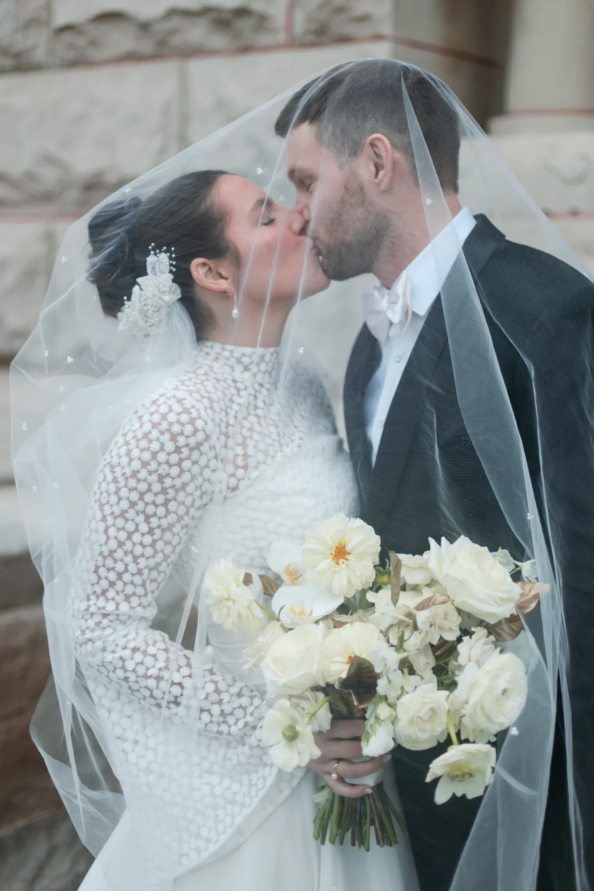 chicago wedding planning engaging events ali ritz carlton bride groom veil kiss - A Golden Ritz-Carlton Chicago Celebration Bride and groom share intimate kiss under flowing veil at Ritz-Carlton Chicago wedding planned by Engaging Events by Ali