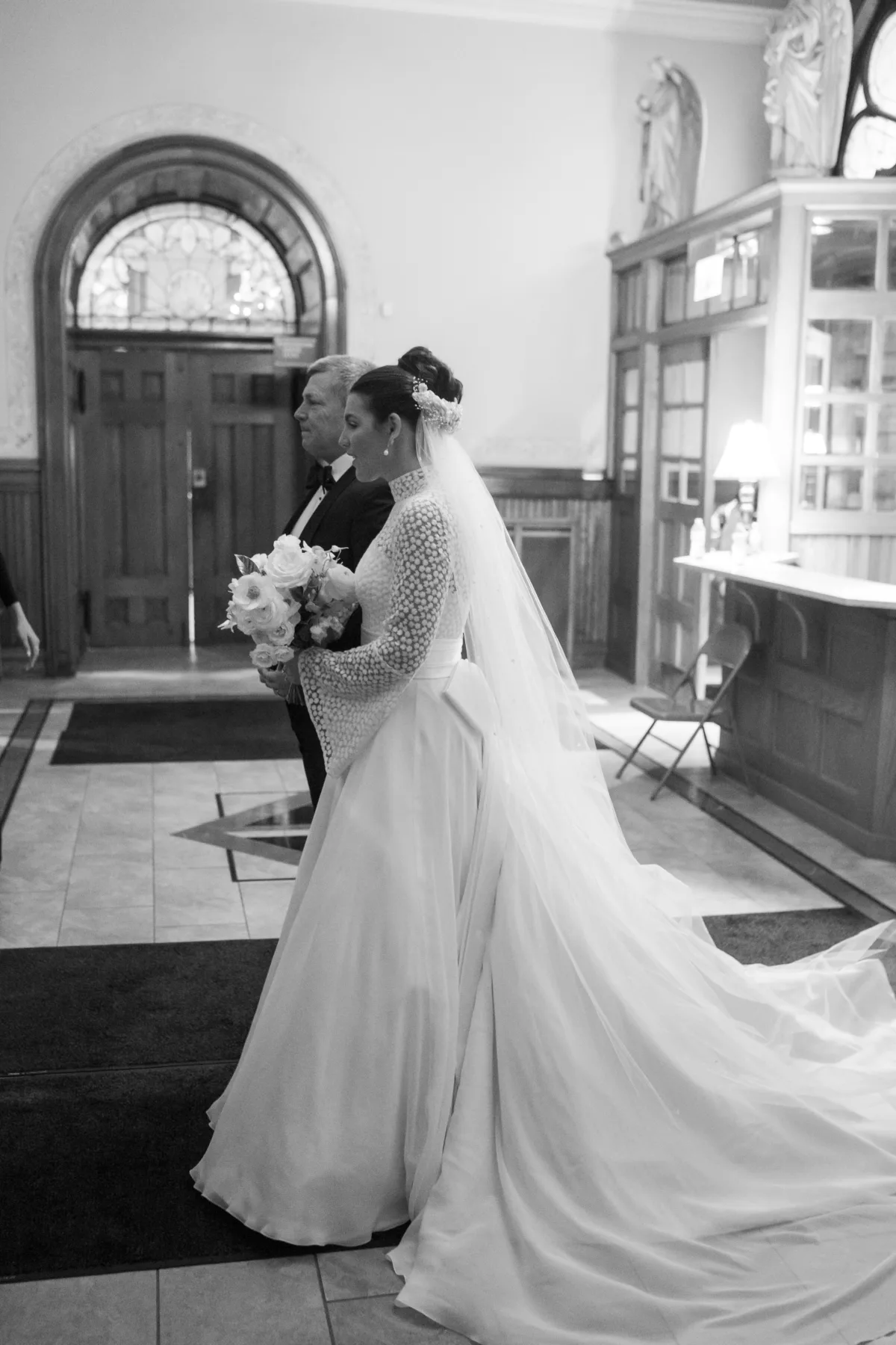 chicago wedding planning engaging events by ali bride walking down aisle - A Golden Ritz-Carlton Chicago Celebration Bride in elegant wedding gown with long train walking down the aisle at wedding planned by Engaging Events by Ali