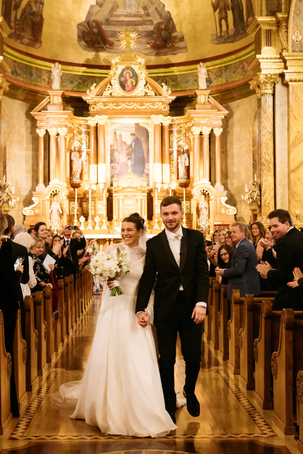 chicago wedding planning engaging events by ali church ceremony - A Golden Ritz-Carlton Chicago Celebration Newlyweds walking down the aisle after their Chicago church wedding ceremony, coordinated by Engaging Events by Ali
