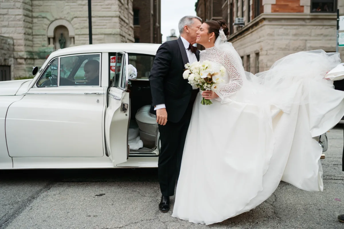 chicago wedding planning engaging events by ali ritz carlton bride father vintage car - A Golden Ritz-Carlton Chicago Celebration Bride and father share intimate moment beside vintage white car on Chicago street, coordinated by Engaging Events by Ali for Ritz-Carlton wedding celebration