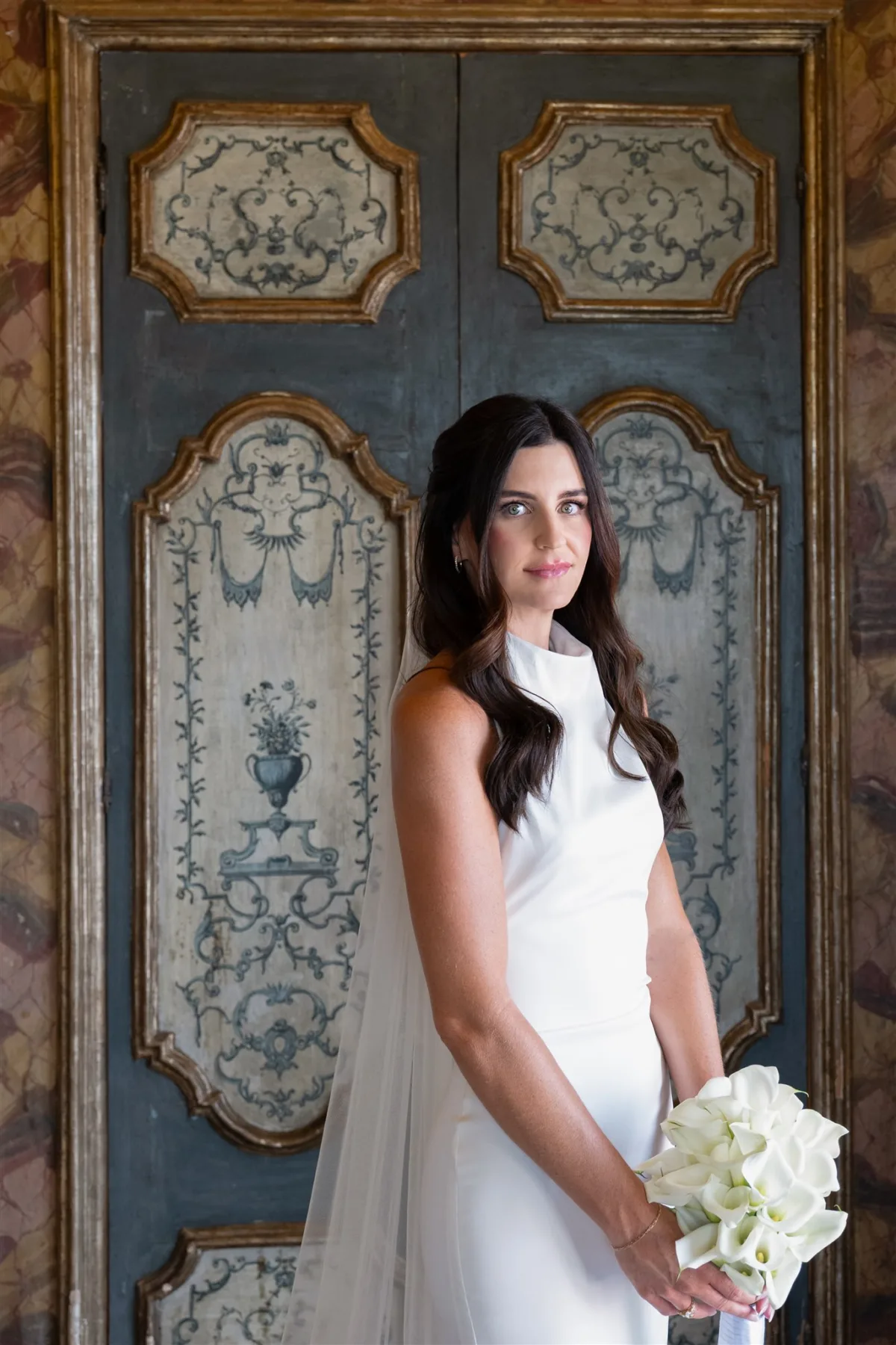 destination wedding planning amalfi coast engaging events ali sorrento bridal portrait - An Effortless Amalfi Coast Celebration Elegant bridal portrait at Capo Santa Fortunata in Sorrento Italy planned by Chicago wedding planner Engaging Events by Ali with white bouquet against ornate Italian doors