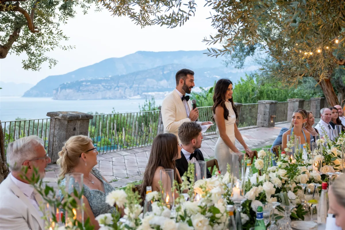 engaging events ali amalfi coast wedding planning sorrento - An Effortless Amalfi Coast Celebration Groom giving speech at elegant outdoor wedding reception planned by Engaging Events by Ali at Capo Santa Fortunata in Sorrento Italy with stunning Amalfi Coast views