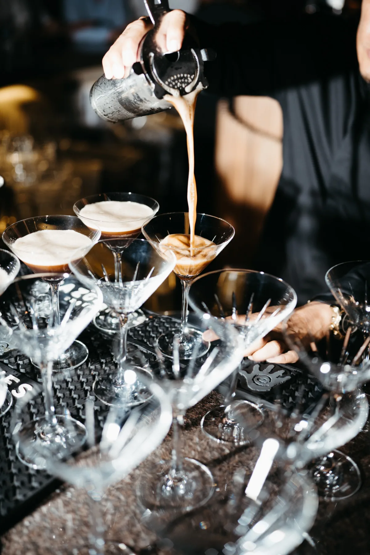 luxury cabo destination wedding cocktail service cape thompson hotel - Luxury Cabo Wedding at The Cape, a Thompson Hotel Professional bartender pouring cocktails into martini glasses at luxury Cabo destination wedding at The Cape Thompson Hotel planned by Engaging Events by Ali