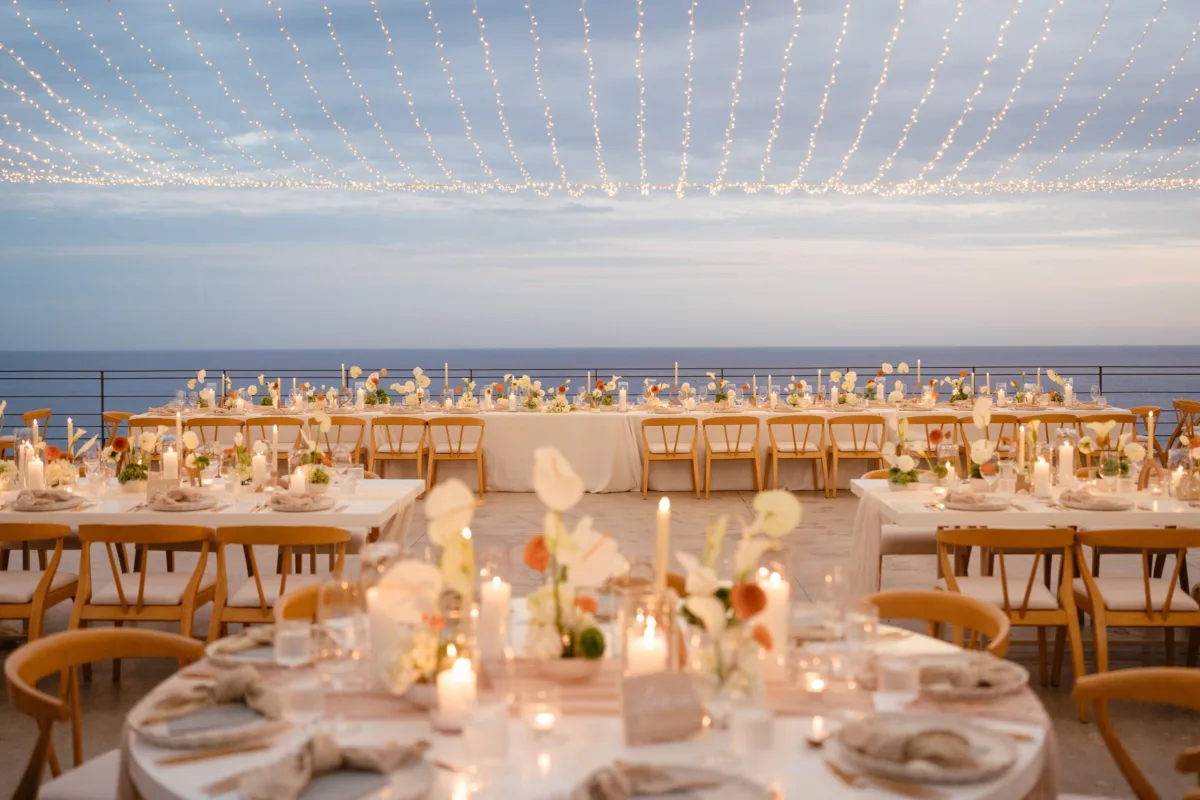 luxury cabo destination wedding reception the cape thompson hotel engaging events ali - Luxury Cabo Wedding at The Cape, a Thompson Hotel Elegant outdoor wedding reception with string lights overlooking the ocean at The Cape Thompson Hotel in Cabo planned by Engaging Events by Ali
