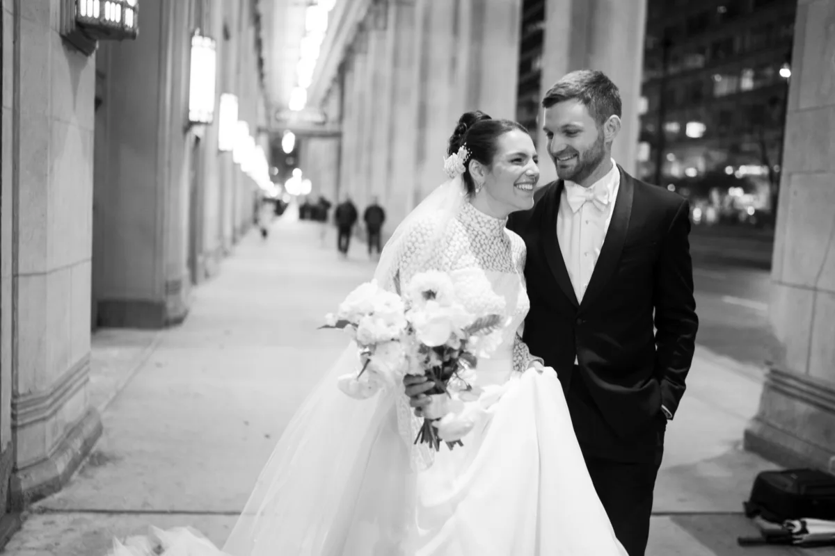 wedding planning engaging events ritz carlton chicago couple portrait - A Golden Ritz-Carlton Chicago Celebration Bride and groom walking together in downtown Chicago after their Ritz-Carlton wedding planned by Engaging Events by Ali