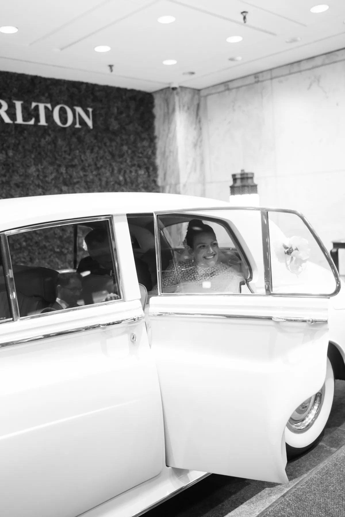 wedding planning ritz carlton chicago bride vintage car engaging events ali - A Golden Ritz-Carlton Chicago Celebration Bride smiling in vintage white car at Ritz-Carlton Chicago wedding planned by Engaging Events by Ali